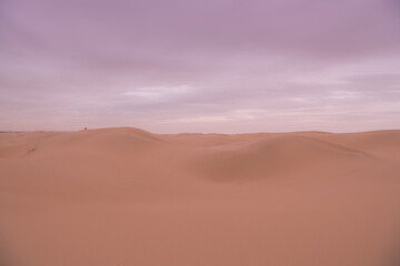 Fototapeta na wymiar Dramatic sky over the never-ending sand dunes of Gobi desert in Inner Mongolia