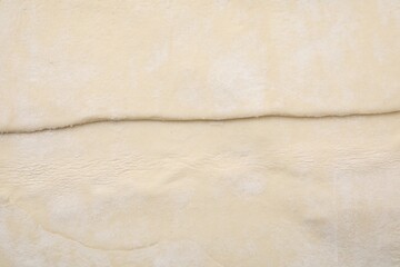 Fototapeta na wymiar Raw puff pastry dough as background, top view