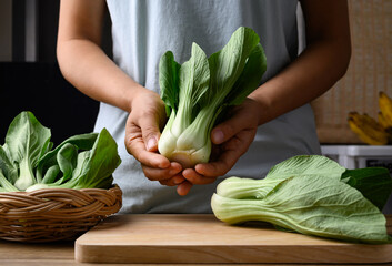 Bok choy or Pak choi (Chinese cabbage) with woman hand prepare for cooking, Organic vegetables - obrazy, fototapety, plakaty