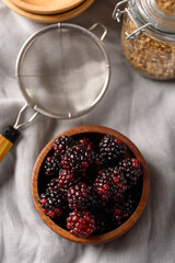Fresh blackberry fruit in a brown wooden bowl