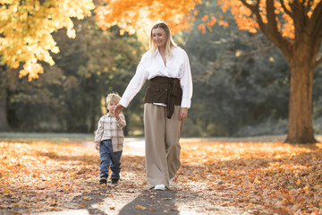Mothers day, love family.  Family on autumn walk in nature outdoors. Mother and child with hugging tenderness