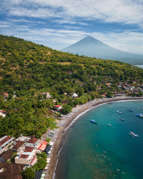 Aerial view of the northern coast of Bali and the Agung volcano. Blue water. Black beaches. Amed. Bali. Indonesia