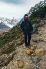 woman with winter clothes hiking on Cerro Torre in Argentine Patagonia