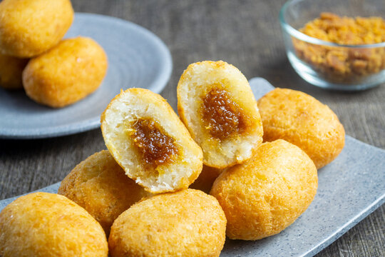Misro is a typical snack from West Java Indonesia. This snack is made from grated cassava, the inside of which is filled with brown sugar and then fried. served on a plate with a dark table mat