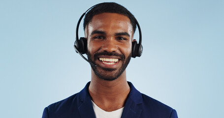 Happy man, portrait and headphones for call center or telemarketing against a blue studio...