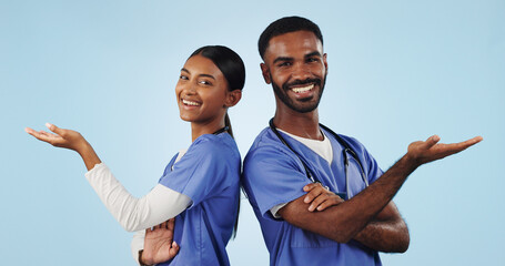 Portrait, teamwork or doctors with palm space or mockup in studio isolated on blue background....