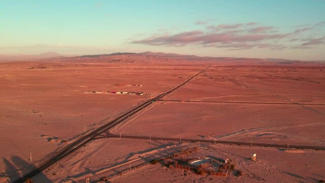 Aerial view of a unique street in the northern desert of Chile with the arid mountains in the background, sunset, Coquimbo Region.