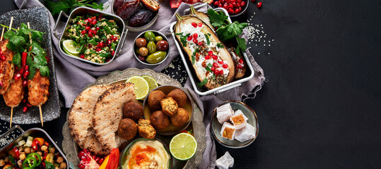 Middle eastern or Arabic different dishes on black background. Tasty traditional food concept
