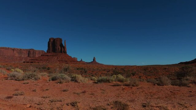 Monument Valley in Arizona and Utah. Driving along red rock formations in scenic iconic wild west landscape.