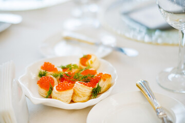 canape with red caviar on table