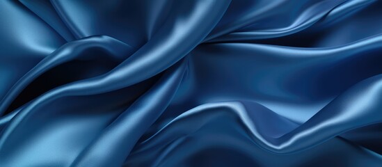 Dark blue abstract background. Silk satin material. Soft wavy folds.