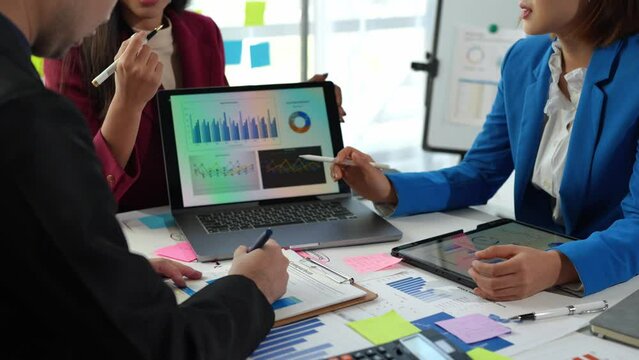 Startup business team meeting working on graph document and laptop new business project, Group of Business People Diverse Brainstorm Meeting Concept.