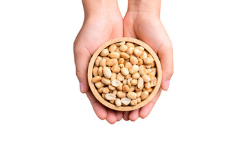 Peanuts in wooden bowl holding by hand, Top view