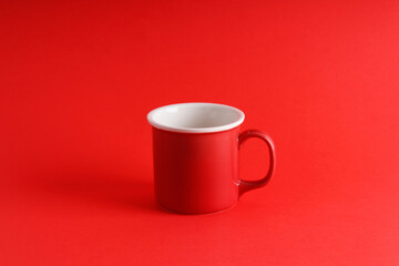 Red mug on an isolated red background, new year and christmas theme