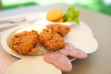 Closeup cute meal tray for kid on blur table background with fried chicken ,fresh appetizing food separate in section,eating healthy food.