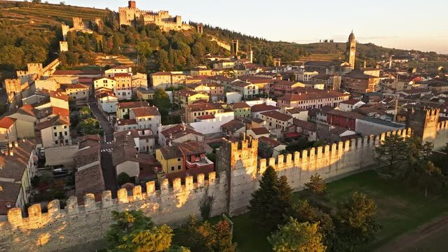 Medieval Scaliger Turreted Walls In Soave Town During Golden Hour In Northern Italy. - aerial shot
