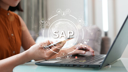 System Applications and Product (SAP). Program helps manage business to access information quickly accurately. Woman using laptop holding magnifying glass with SAP text inside. An icon on background. - obrazy, fototapety, plakaty