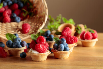 Small tartlets with fresh raspberries and blueberries.