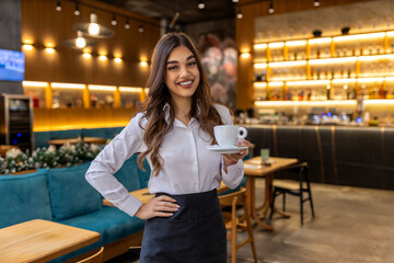 Portrait of a Happy woman Standing In Front of Coffee Shop hand with Cup of Coffee small business welcome reopen again, female smiling barista holding coffee - obrazy, fototapety, plakaty