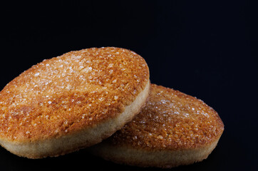 eautiful round cookies on a black background. A few cookies. Two cookies.