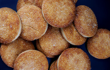 Beautiful round cookies on a black background. A few cookies. Cookies background.