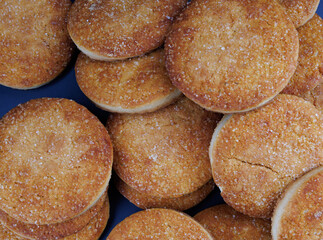 Beautiful round cookies on a black background. A few cookies. Cookies background.