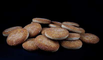 Beautiful round cookies on a black background. A few cookies. A bunch of cookies.
