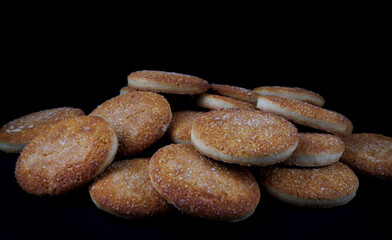 Beautiful round cookies on a black background. A few cookies. A bunch of cookies.