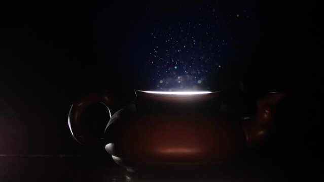 Light coming out of a clay teapot