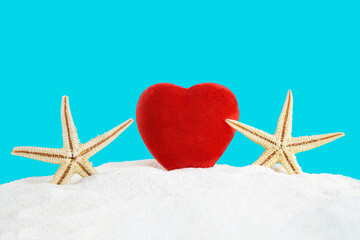 Red heart with sea stars on the sand of the beach with the sea. Valentine's Day, February 14,...