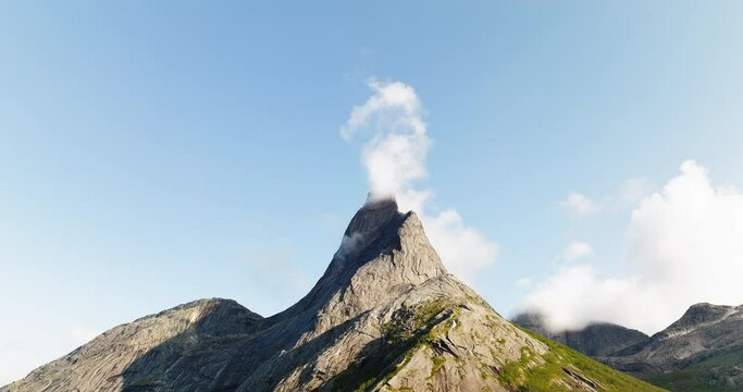 Distinctlive Stetinden peak against blue sky with thin cloud, Nordland. Aerial