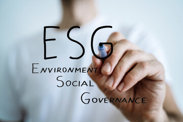 ESG strategy concept. Environmental, sustainable, governance. Businessman writes ESG