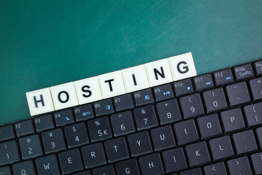 laptop keyboard and alphabet letters with the word hosting. Internet database