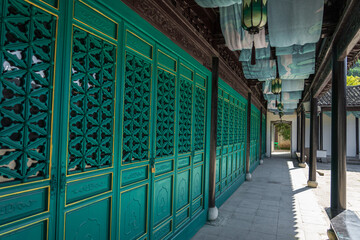 Promenade and green wooden doors in ancient Chinese architecture