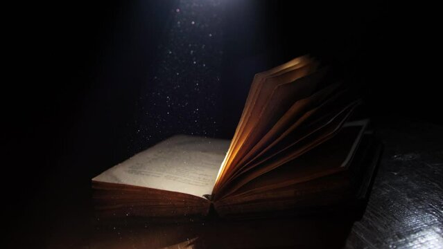A ray of light falling on an old open book