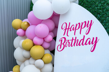 Happy birthday, pink letters, font style. White paper background. Party event. Yellow , white and...