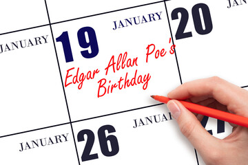 January 19. Hand writing text Edgar Allan Poe's Birthday on calendar date. Save the date.