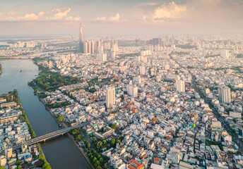 Panoramic view of Saigon, Vietnam from above at Ho Chi Minh City's central business district. Cityscape and many buildings, local houses, bridges, rivers - obrazy, fototapety, plakaty