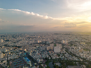 Panoramic view of Saigon, Vietnam from above at Ho Chi Minh City's central business district. Cityscape and many buildings, local houses, bridges, rivers