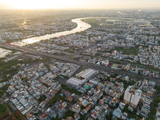 Panoramic view of Saigon, Vietnam from above at Ho Chi Minh City's central business district. Cityscape and many buildings, local houses, bridges, rivers