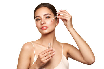 Young beautiful woman applying face serum with pipette. Cosmetic procedures for facial skin care