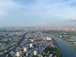 Fototapeta premium Panoramic view of Saigon, Vietnam from above at Ho Chi Minh City's central business district. Cityscape and many buildings, local houses, bridges, rivers