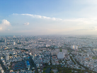 Fototapeta na wymiar Panoramic view of Saigon, Vietnam from above at Ho Chi Minh City's central business district. Cityscape and many buildings, local houses, bridges, rivers