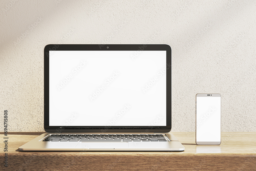 Poster close up of empty white laptop and smartphone on wooden desk. concrete wall background. device prese
