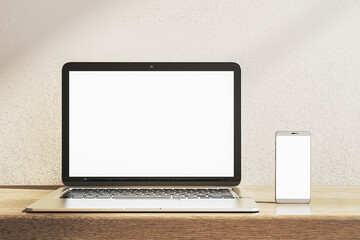 Close up of empty white laptop and smartphone on wooden desk. Concrete wall background. Device presentation and online education concept. Mock up, 3D Rendering.