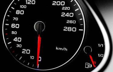 Close up shot of a speedometer in a car. Car dashboard. Dashboard details with indication lamps. Car instrument panel.