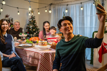 Asian family taking a photo while celebrate christmas party together. 