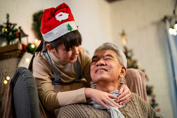 Asian young kid grandchild visit senior grandfather during Christmas.