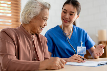 Asian young caregiver nurse examine senior woman patient at home. 