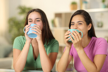 Funny women drinking coffee at home